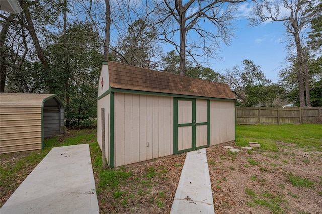 view of shed featuring fence