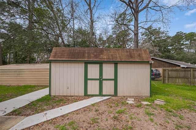 view of shed with fence