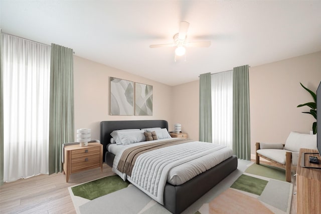 bedroom with light wood-type flooring and a ceiling fan