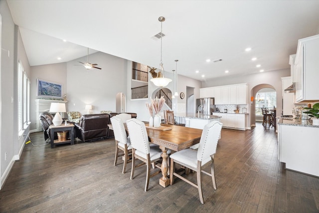 dining space with arched walkways, recessed lighting, visible vents, dark wood-type flooring, and baseboards