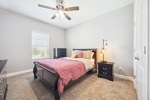 bedroom with light carpet, ceiling fan, and baseboards