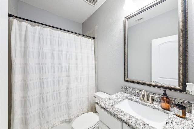 full bathroom with toilet, a textured wall, vanity, and visible vents