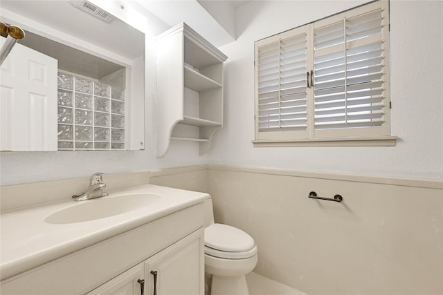 bathroom featuring toilet, visible vents, and vanity