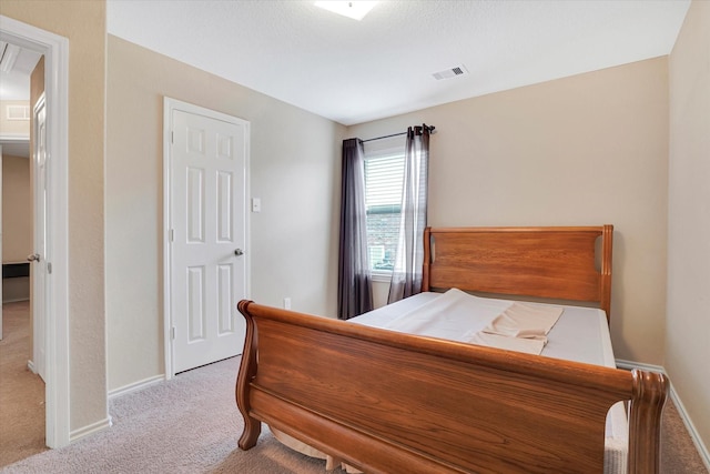 bedroom featuring carpet flooring, visible vents, and baseboards