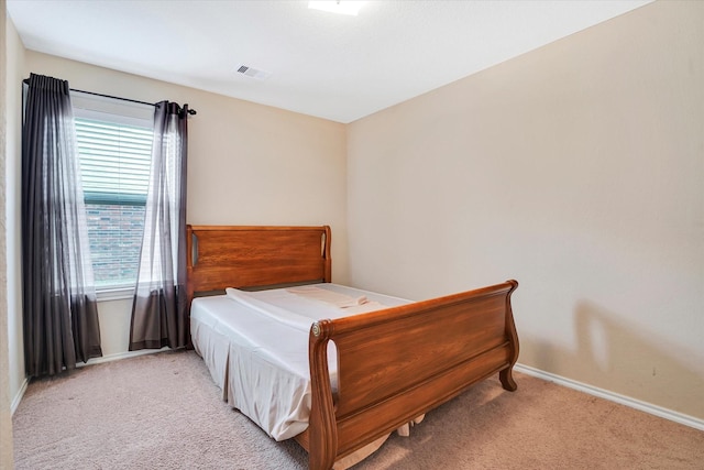 carpeted bedroom featuring visible vents and baseboards