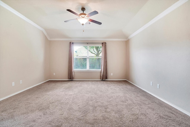 carpeted empty room featuring a ceiling fan, crown molding, and baseboards