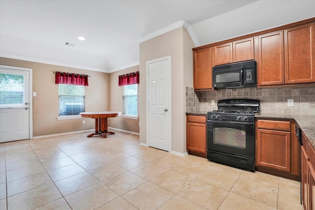 kitchen with black appliances, tasteful backsplash, and brown cabinets