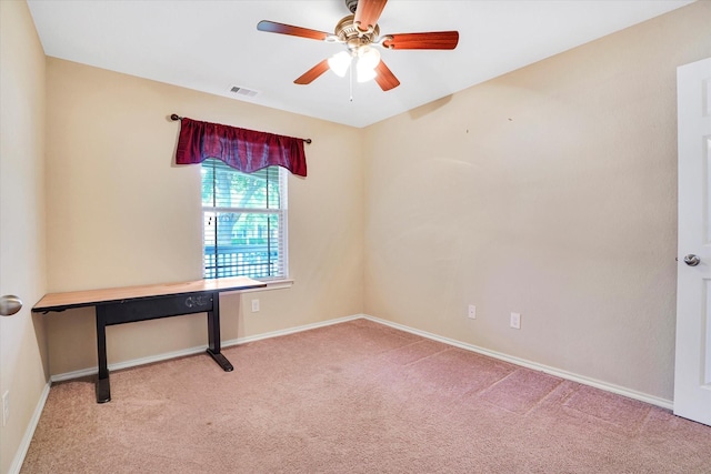 carpeted empty room with baseboards, visible vents, and ceiling fan