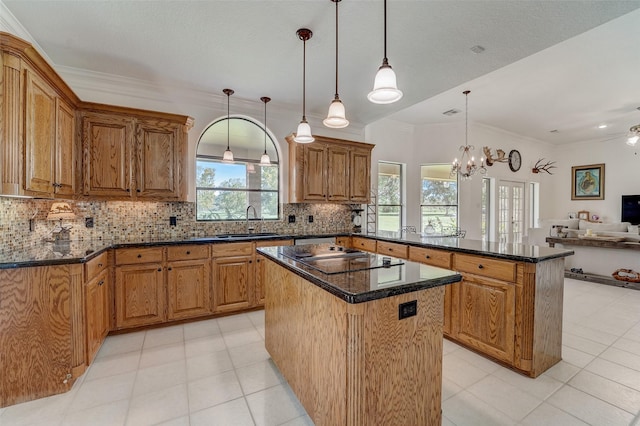 kitchen with a center island, open floor plan, a sink, a peninsula, and black electric cooktop