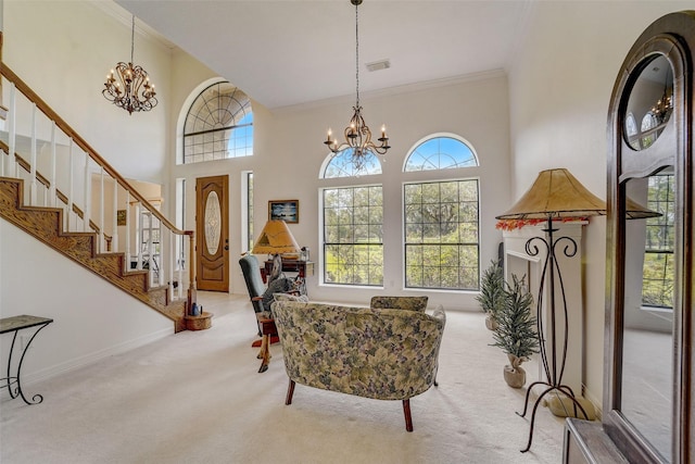 sitting room featuring carpet, visible vents, a notable chandelier, and ornamental molding