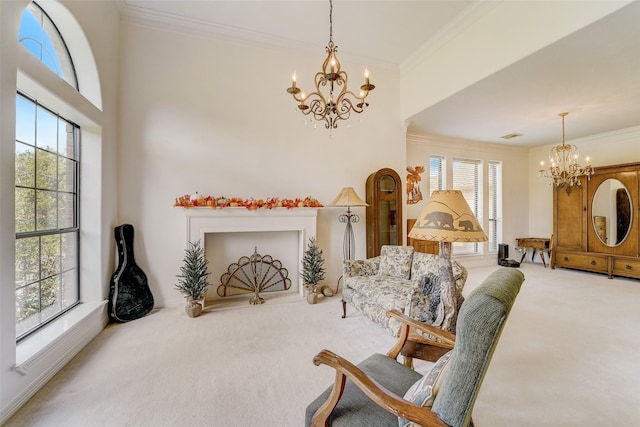 sitting room with a chandelier, carpet, and crown molding