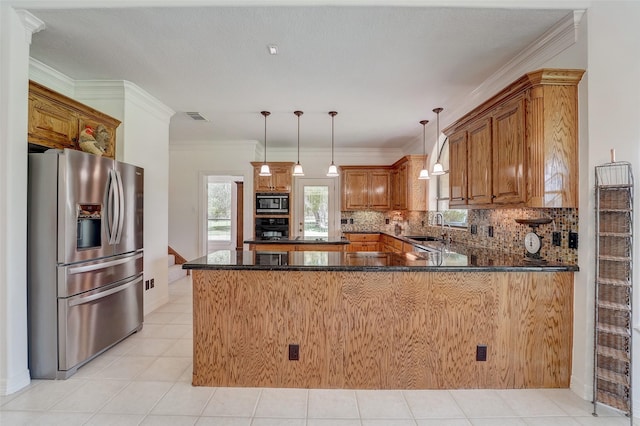 kitchen featuring a peninsula, a sink, visible vents, stainless steel fridge with ice dispenser, and built in microwave