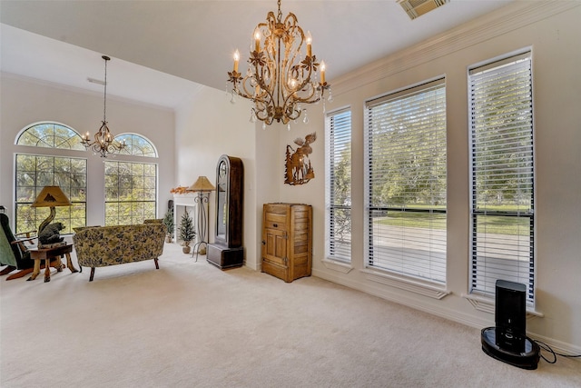 sitting room with ornamental molding, carpet flooring, visible vents, and a notable chandelier