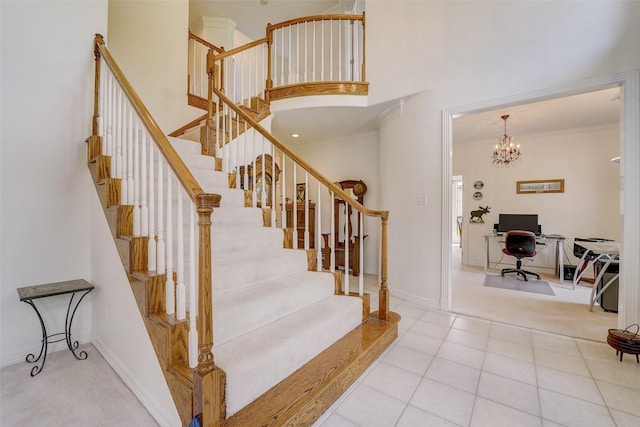 stairway featuring a high ceiling, baseboards, ornamental molding, and tile patterned floors