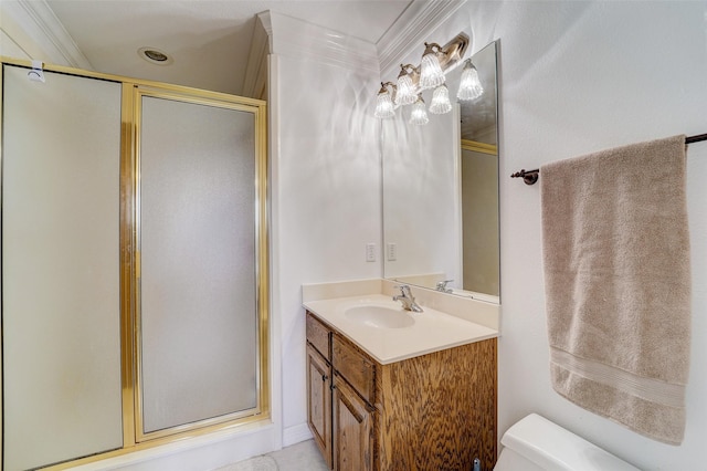 bathroom featuring toilet, a shower stall, crown molding, and vanity