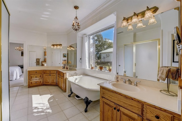 full bathroom featuring ornamental molding, tile patterned flooring, a freestanding tub, and vanity