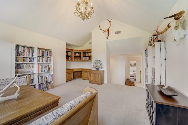 sitting room featuring built in desk, visible vents, an inviting chandelier, light carpet, and high vaulted ceiling