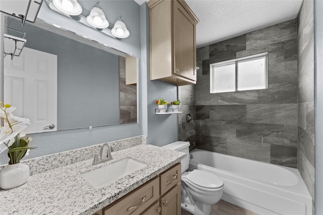 bathroom with shower / bathtub combination, a textured ceiling, toilet, and vanity