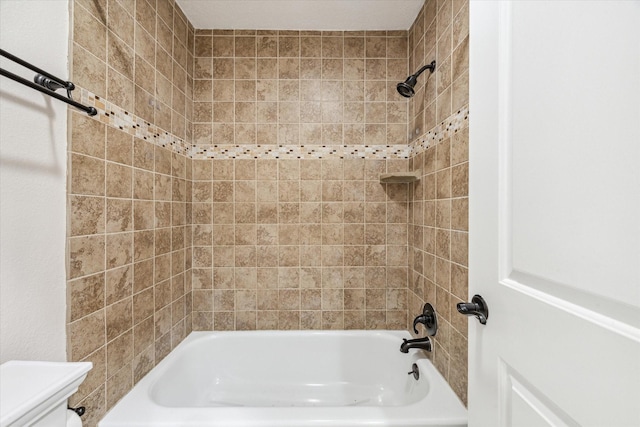 bathroom featuring shower / bath combination and toilet