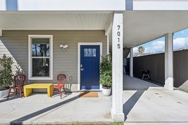 property entrance with a patio area and fence