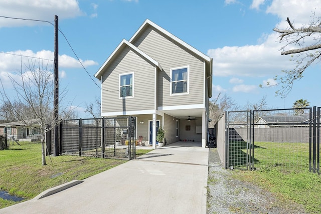 view of front of property with a front yard, concrete driveway, fence, and a gate