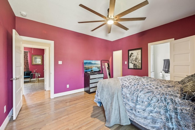 bedroom with ceiling fan, light wood-style flooring, and baseboards