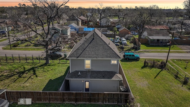 aerial view at dusk featuring a residential view