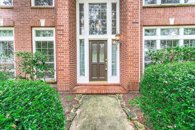 doorway to property with brick siding