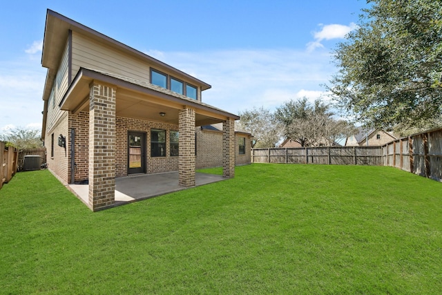 rear view of house featuring a yard, a fenced backyard, central AC, a patio area, and brick siding