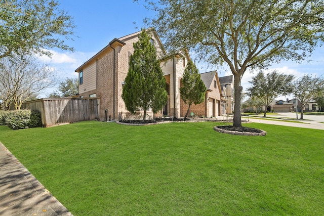 view of side of property with brick siding, a lawn, and an attached garage