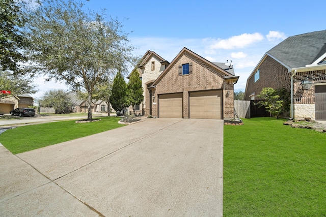 view of front of property featuring a front lawn, fence, concrete driveway, an attached garage, and brick siding