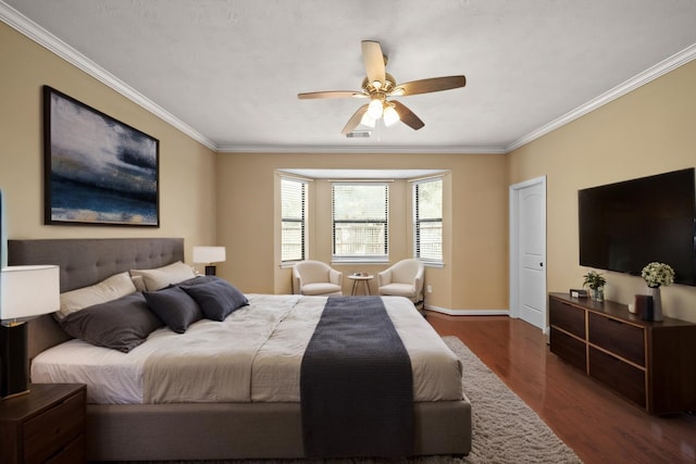 bedroom featuring baseboards, dark wood-type flooring, ornamental molding, and a ceiling fan