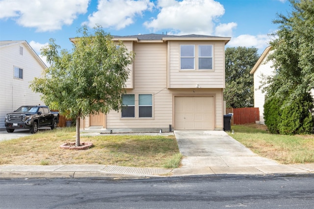 view of front facade featuring driveway, a garage, fence, and a front lawn