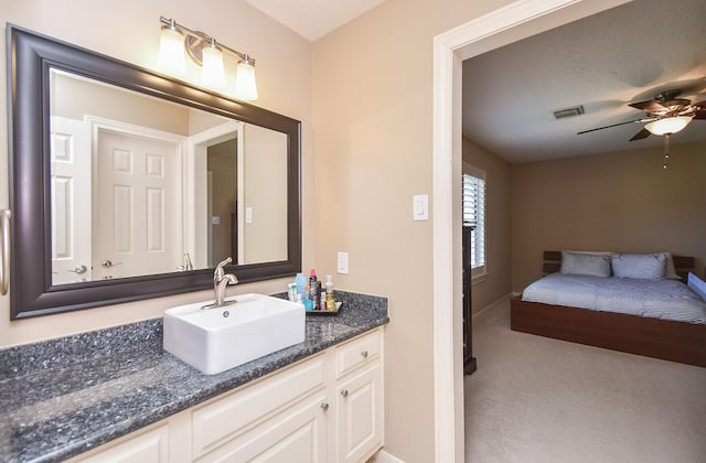 bathroom featuring vanity, a ceiling fan, and visible vents