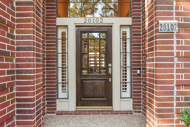 entrance to property with brick siding