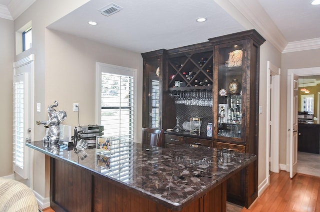 bar featuring recessed lighting, visible vents, light wood finished floors, and ornamental molding