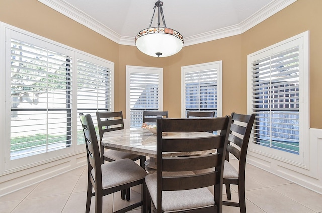 dining room with light tile patterned floors and ornamental molding