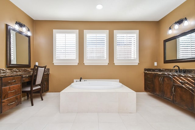 full bathroom with a wealth of natural light, vanity, and tile patterned floors