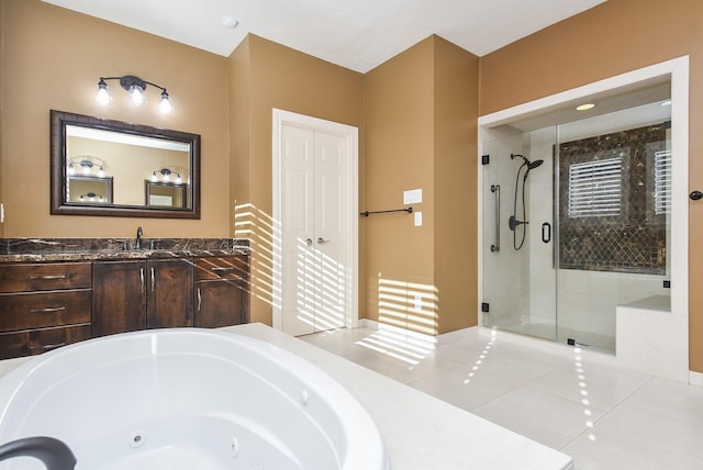 bathroom with vanity, a shower stall, a whirlpool tub, and tile patterned floors