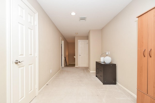 corridor featuring light carpet, visible vents, recessed lighting, and baseboards