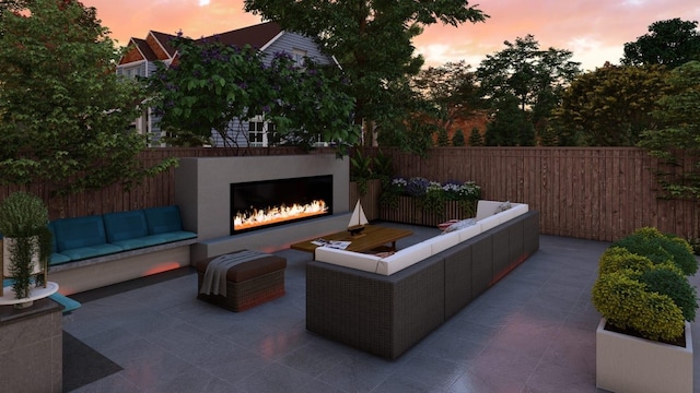 view of patio / terrace featuring fence and an outdoor living space with a fireplace