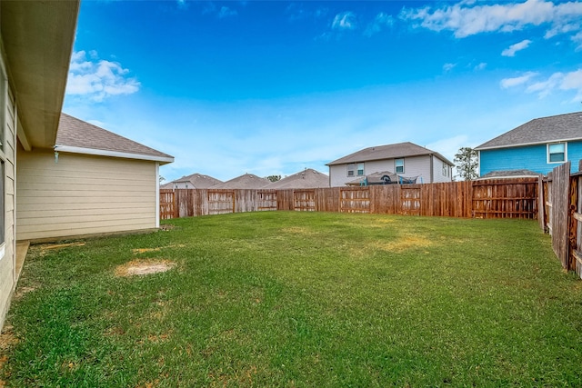 view of yard with a fenced backyard