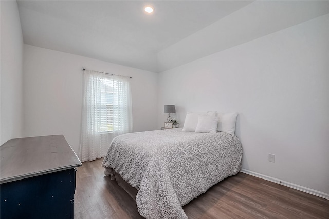 bedroom with recessed lighting, vaulted ceiling, baseboards, and wood finished floors