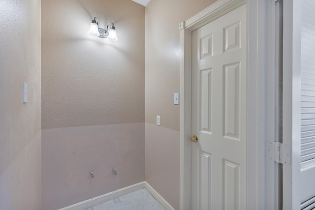 interior space featuring tile patterned flooring and baseboards