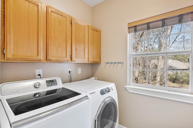 laundry room with cabinet space and washer and clothes dryer