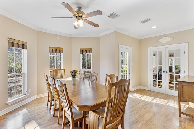 dining room with french doors, light wood-type flooring, visible vents, and baseboards