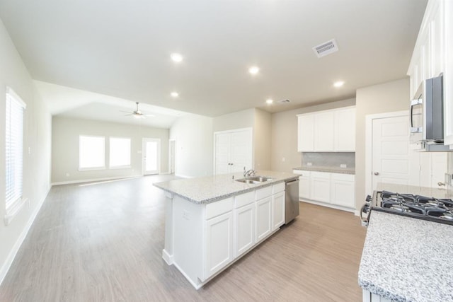 kitchen featuring stainless steel appliances, light wood-type flooring, visible vents, and white cabinetry