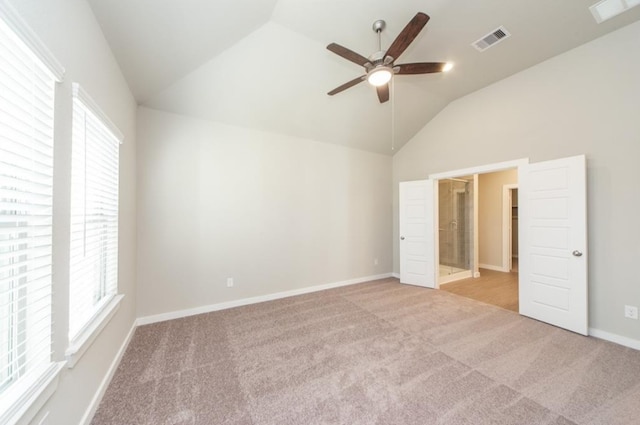 unfurnished bedroom with carpet, visible vents, and vaulted ceiling