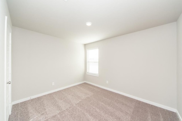 carpeted spare room with baseboards