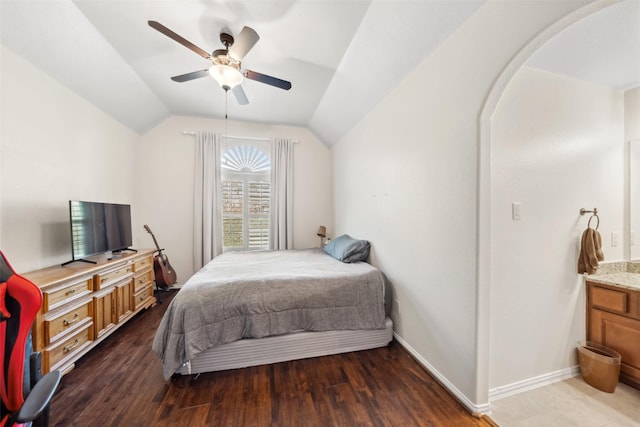 bedroom with lofted ceiling, ceiling fan, baseboards, and wood finished floors